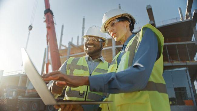 Builders on site working from laptop