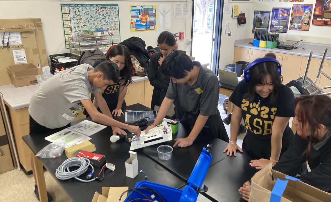 A team of students working on solar battery kit.