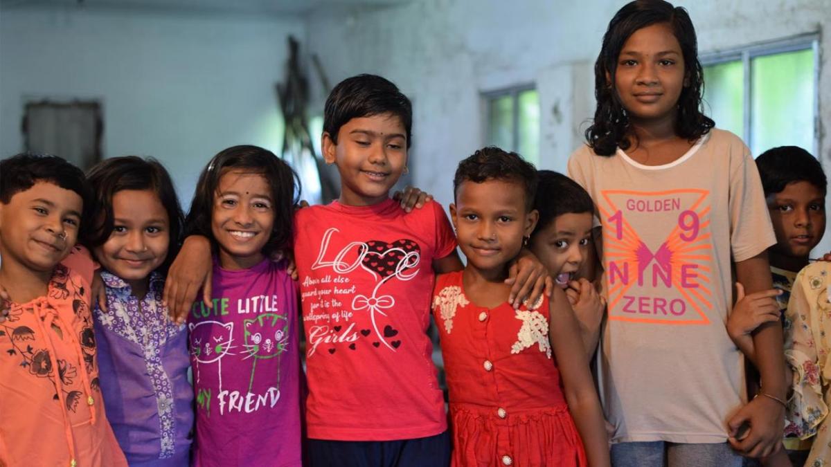 A group of kids with arms around each other.