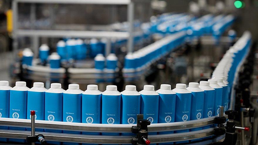 A conveyor line of beverage containers.