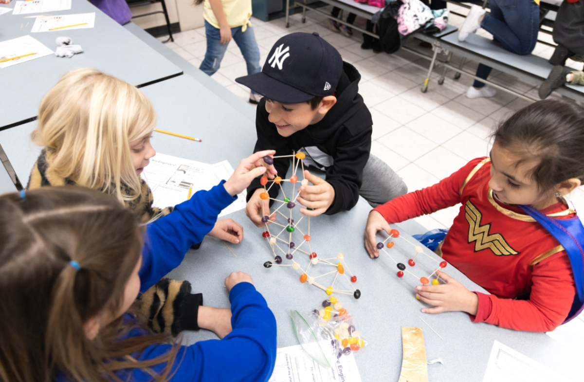 Kids building a tower with toothpicks and jelly beans