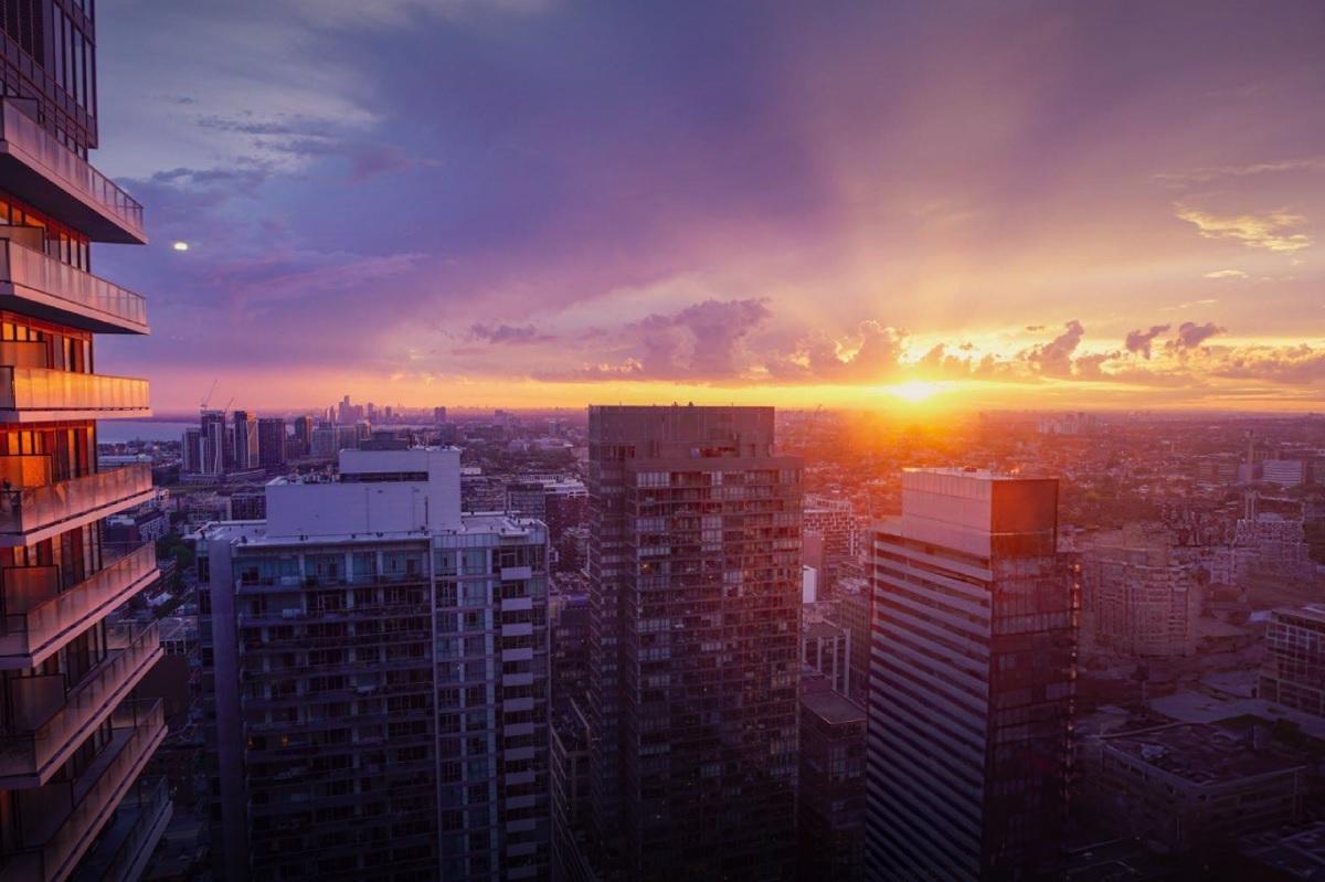 Sunsetting in the distance. A city landscape in front.