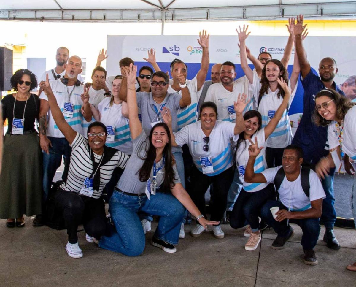 A group of people smiling and raising their arms