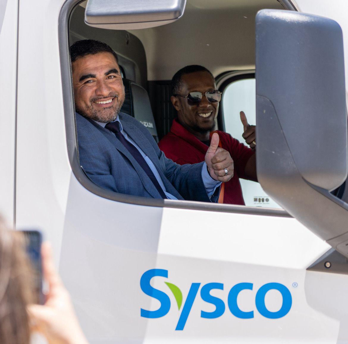 people sitting in a Sysco truck