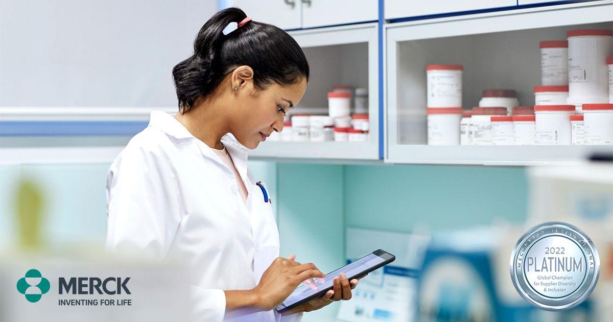 Woman in lab coat on tablet