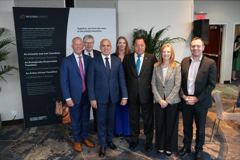 A team of people posed in an open room.