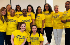 A group of people posed in matching shirts.