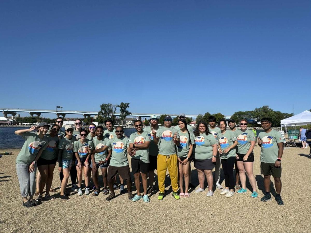 A group posed on a beach.