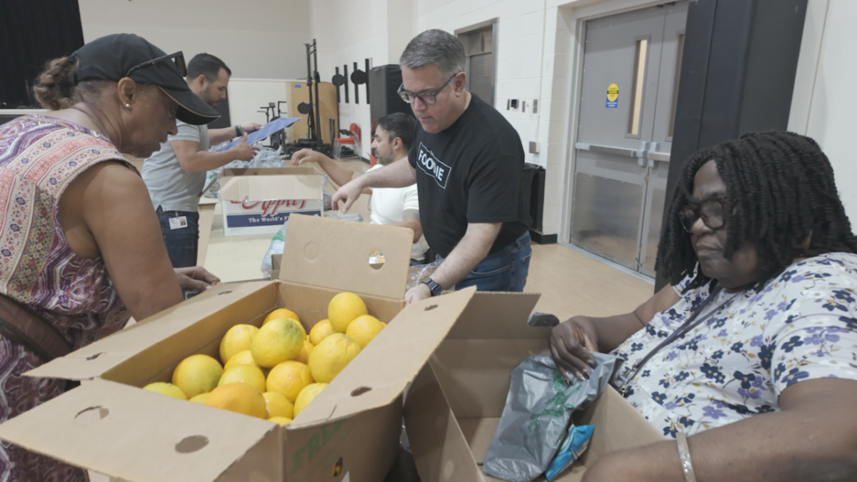 Volunteers unpacking boxes of food.