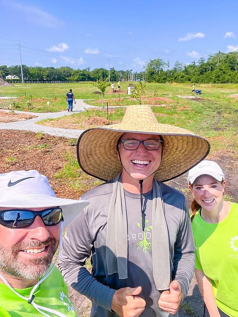 Three people stood together smiling 