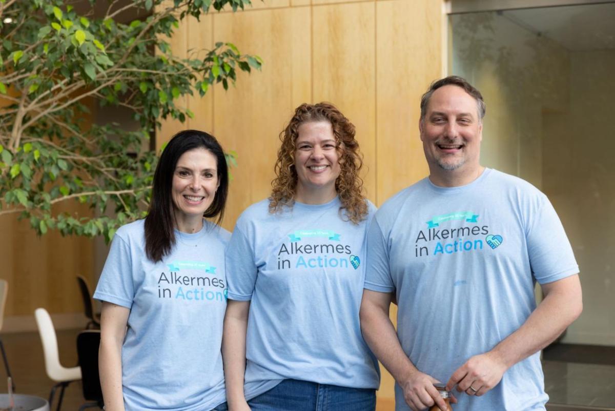 Three volunteers posed in matching tshirts.