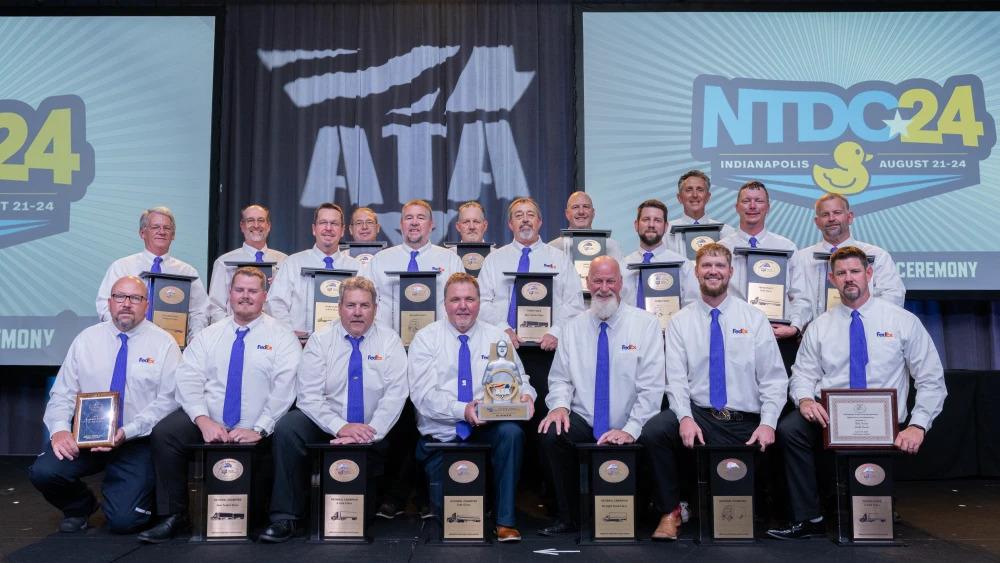 A group posed with awards