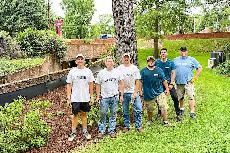 Six volunteers standing outside