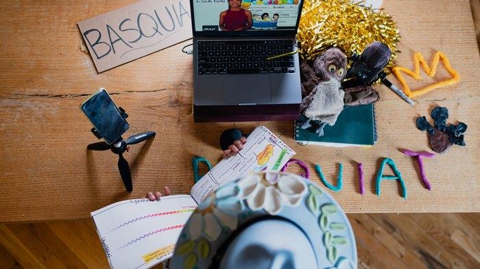 Top down view of person learning with a phone and laptop