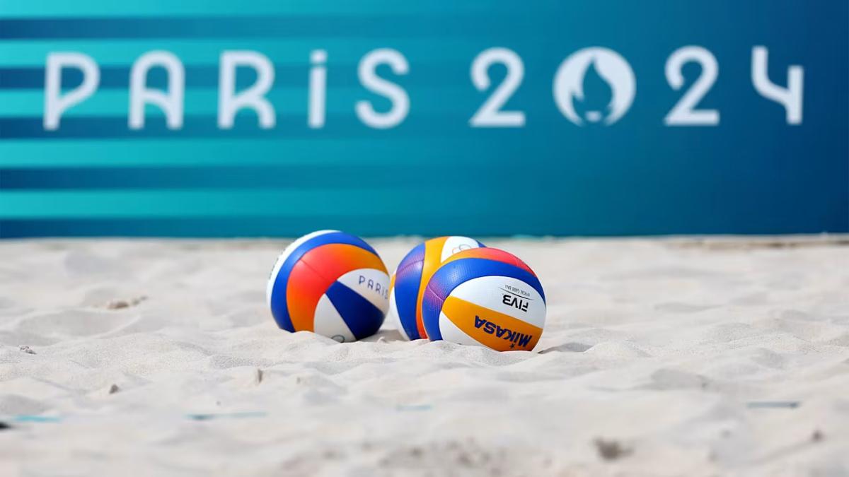 Volleyballs in the sand "Paris 2024" sign in the background.