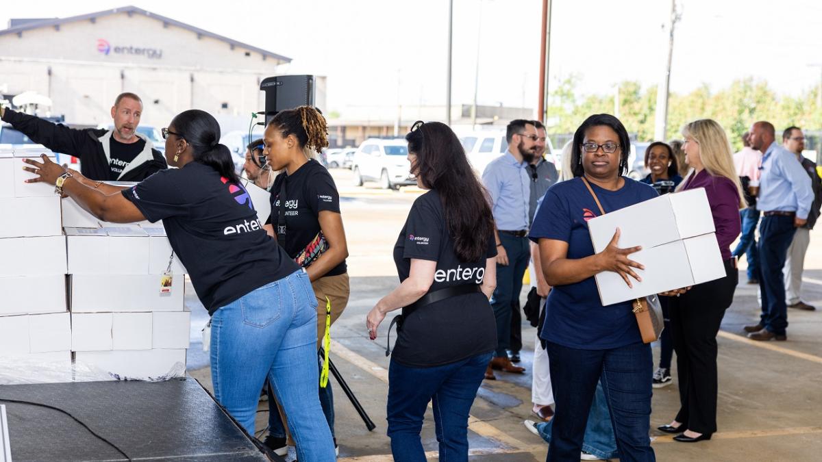 A chain of volunteers passing boxes.