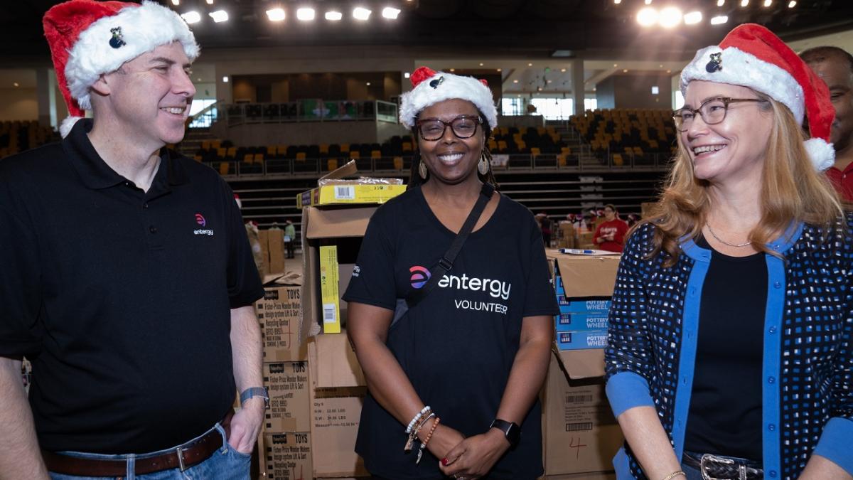 A group of posed volunteers in santa hats.