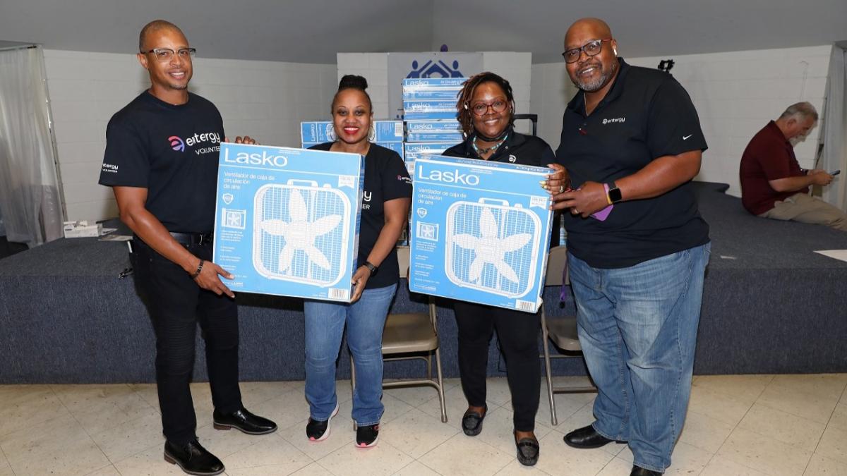 Volunteers posed holding boxed fans.