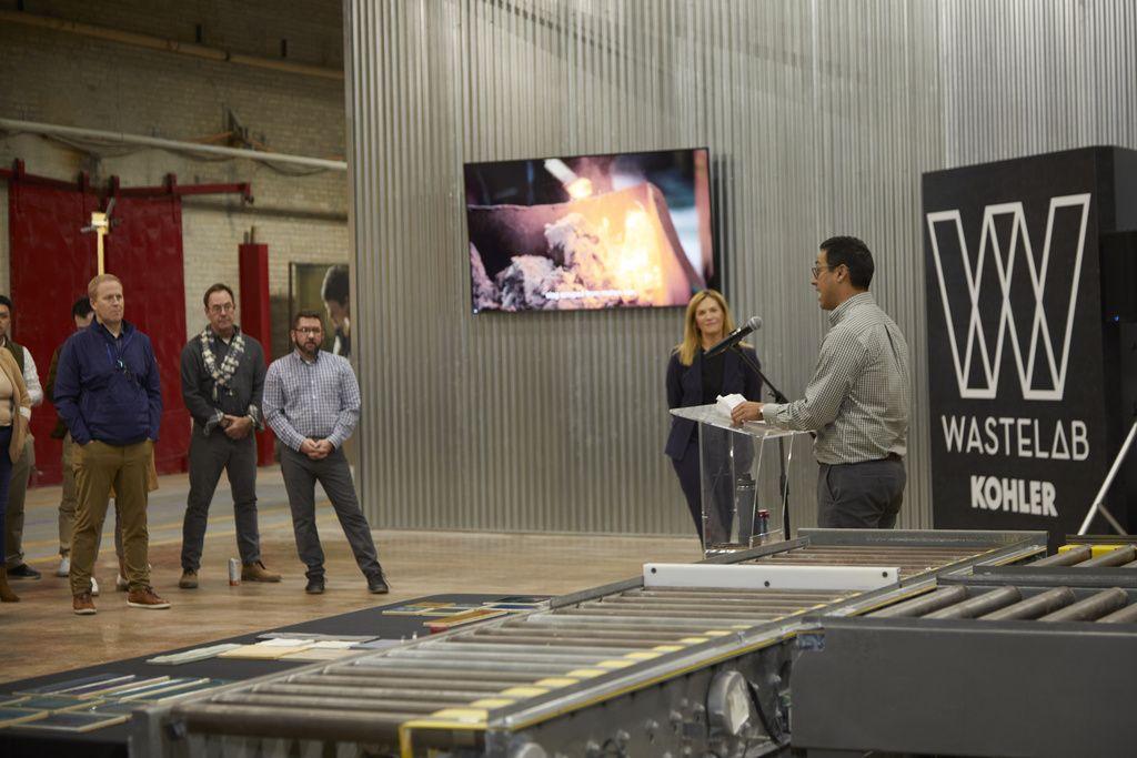 Matthew Sanchez speaking to others "Waste Lab Kohler" behind them.