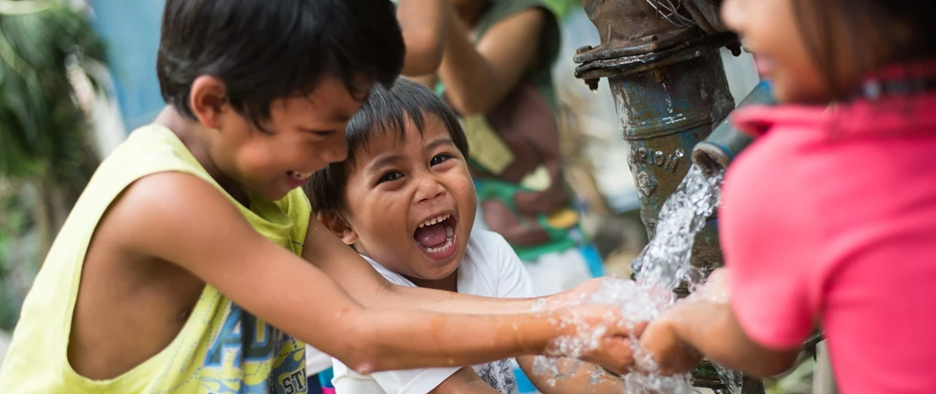 Kids playing in running water