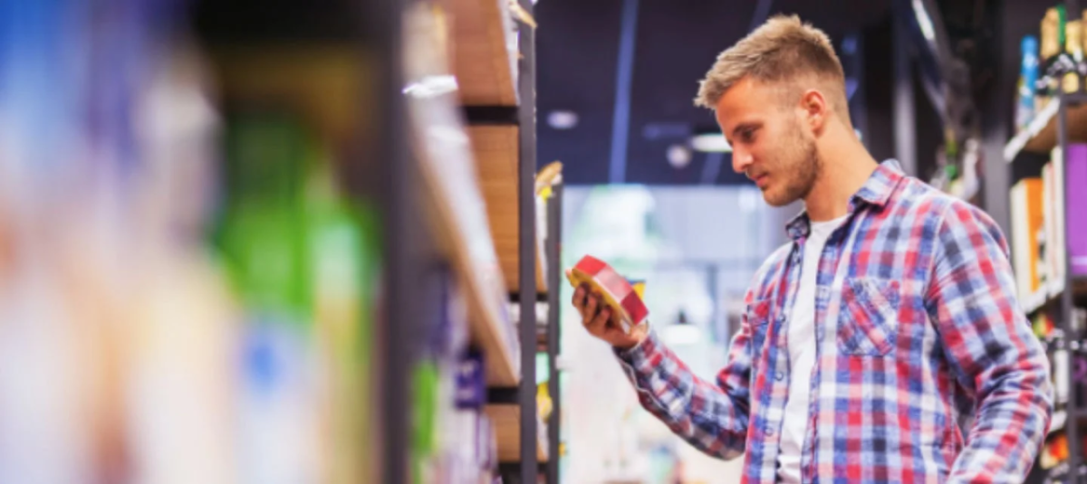 A customer looking at a product from a shelf