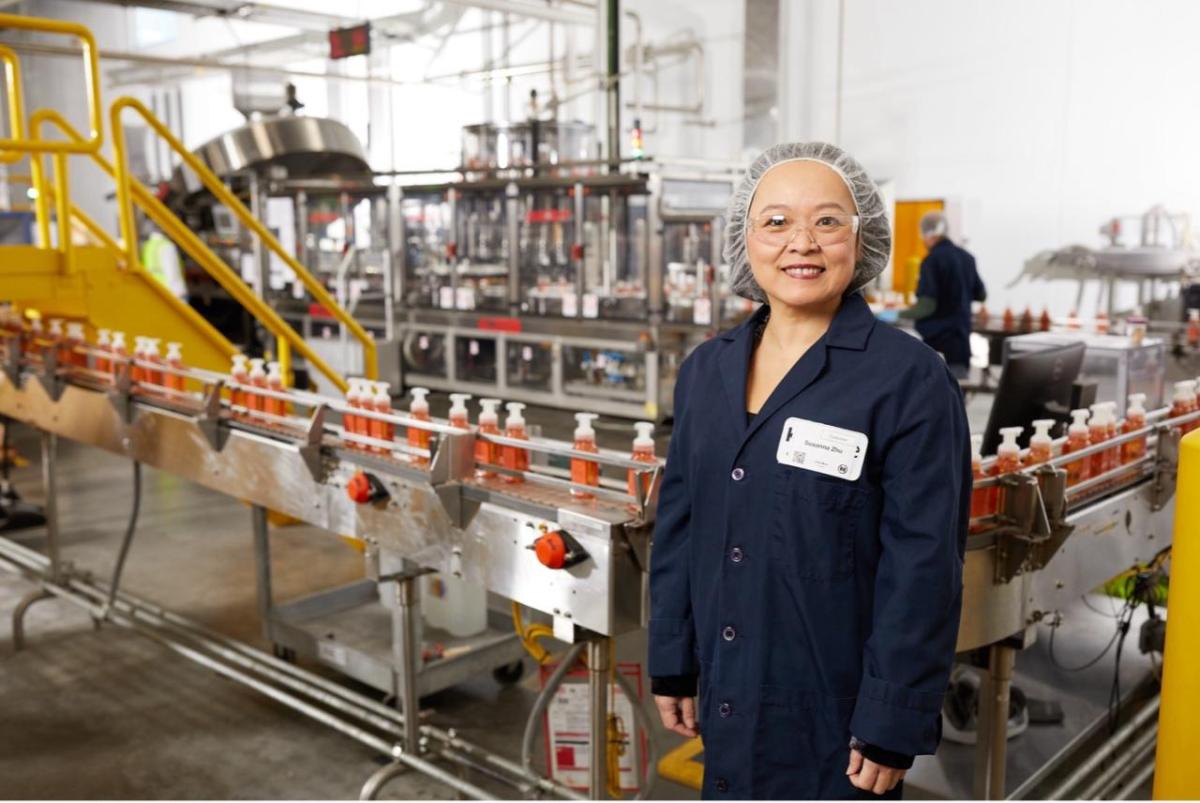 Employee stands in factory