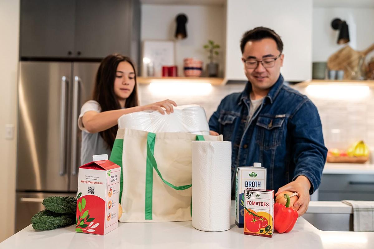 Two people unpacking groceries