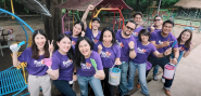 A team of volunteers, smiling to the camera.