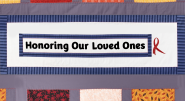 A quilt with "Honoring Our Loved Ones" central.