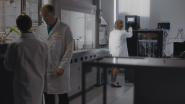 People wearing white lab coats inside a data center