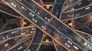 Aerial view of cars driving on multi-lane and multi-level highways.